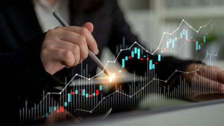 Business professional analyzes financial data using graphs and charts on a digital tablet,...