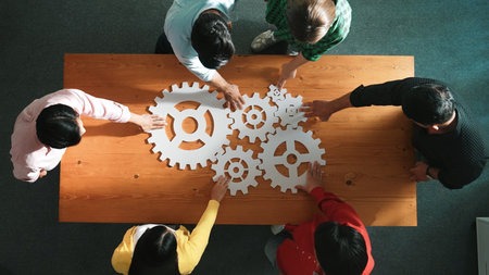 Top view of business people gathering white gear together at meeting table. Group start up team in...