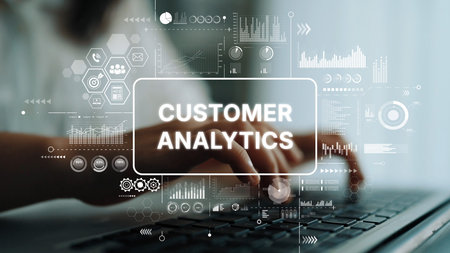 Hands Typing on Laptop with Customer Analytics Graphics and Data Visualization Concepts in a Modern...