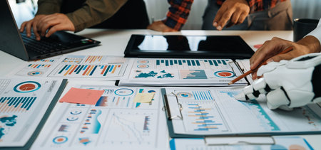 A dynamic business environment showcasing a team analyzing visual data reports during a meeting,...
