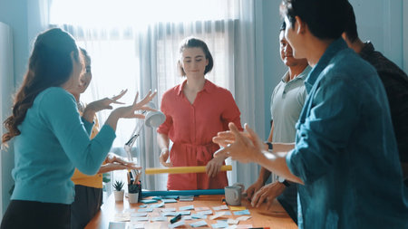 Skilled business team give high five to celebrate successful idea at meeting. Professional diverse...