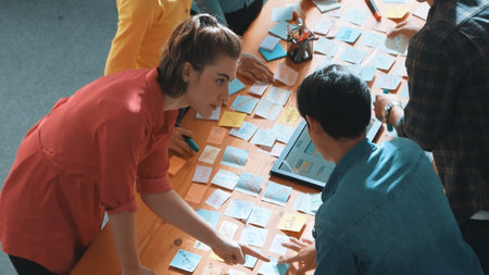 Top view of skilled programmer brainstorming idea about mobile phone interface while develop app...