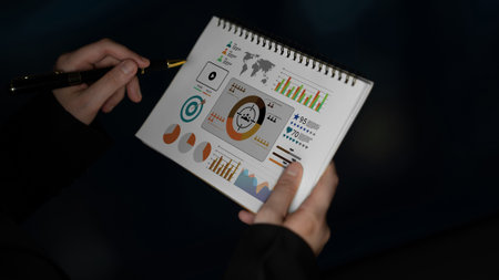 A business professional analyzes vibrant infographics and charts in a modern workspace, highlighting...