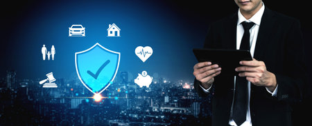 Businessman in Suit Holding Tablet with Digital Security Icons in Night Cityscape for Protection...