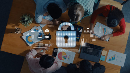 A diverse team collaborates on data analysis in an office setting, utilizing charts and graphs,...