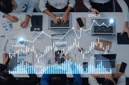 A business team collaborates on financial analysis, using laptops and tablets. Data visualizations...