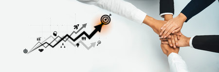 A dynamic representation of teamwork, showcasing hands stacked together with graphs and icons...
