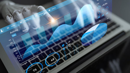 A sleek laptop displays a modern dashboard featuring vibrant graphs and detailed statistical data,...
