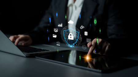 Businessman Interacting with Digital Security Icons While Using Laptop and Tablet in Modern Office...