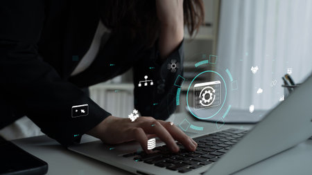 Person Using Laptop with Digital Interface Icons Representing Technology, Data Analysis, and...