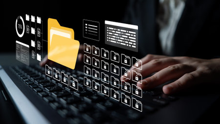 A business professional is working on a laptop surrounded by digital icons representing file management and data security in a modern workspace atmosphere. Ledgerの写真素材