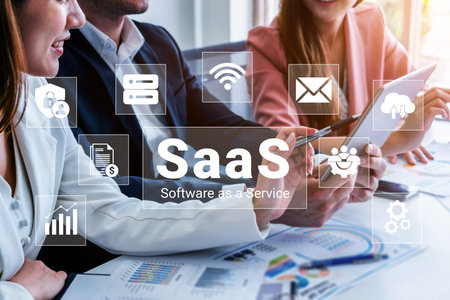 Business professionals actively discuss software as a service solutions using digital devices while...