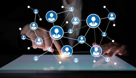 A close-up view of hands interacting with a digital touchscreen, showcasing a network of user icons...
