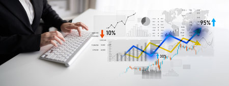 A businessman studies data on a keyboard while surrounded by colorful financial graphs and trends....