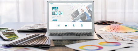 Interior designer workspace table and architecture software on laptop screen with mood board...