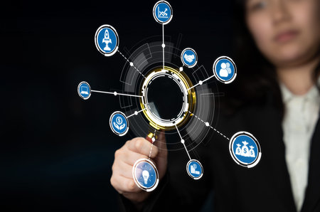 A businesswoman engages with floating digital icons, illustrating concepts of technology and data...