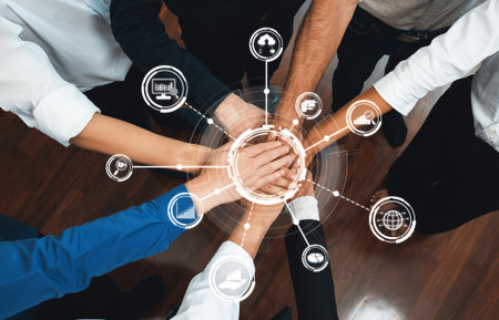 This image captures a collaborative moment of diverse professionals with their hands together,...
