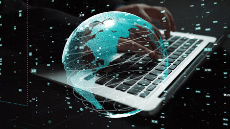 A modern laptop keyboard is highlighted with a digital globe overlay, symbolizing global...