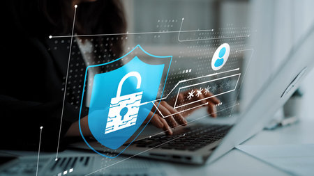 Modern Cybersecurity Concept with Digital Shield and Unlocked Padlock Overlaid on Laptop and User...