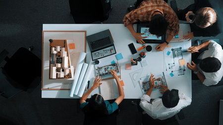 Top aerial view of business people brainstorming about building interior at a table with a house...