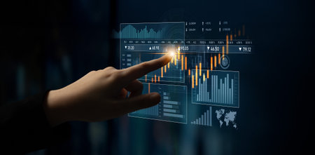 A hand interacts with a digital display featuring various charts and graphs. This image embodies the...