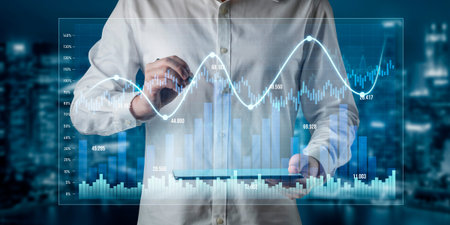 A business professional engages with financial data displayed on a tablet, featuring digital graphs...