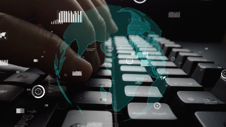 Close-up of hands typing on a keyboard with an abstract digital world overlay, illustrating the...