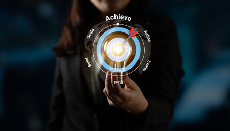 A professional woman focuses on achieving goals through a digital interface, representing business strategy and progression towards success and innovation. Gantry