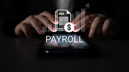 Close-up view of hands typing on a smartphone with a payroll graphic floating above, symbolizing financial management and business growth through modern technology. Ledger