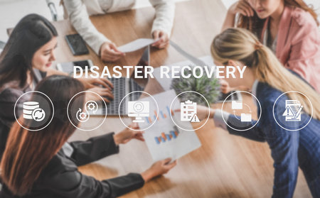 A team of business professionals collaborates on disaster recovery strategies, analyzing data and visual presentations on a conference table in a modern office environment. Ledger