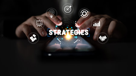Hands Using Smartphone to Access Digital Strategies with Various Icons Representing Innovation, Growth, and Collaboration in a Dark Environment Quark.