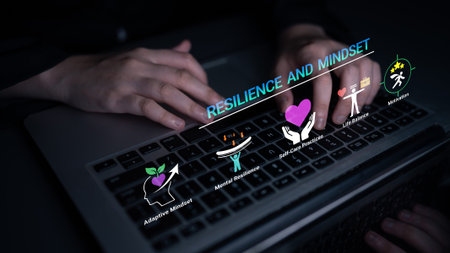 Hands Typing on Laptop Keyboard with Icons Representing Resilience, Mindset, and Mental Health Concepts in Dark Environment Haptic.