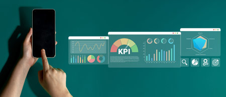 A person interacts with a smartphone displaying data visualizations and KPI metrics, highlighting modern technology role in business performance and analytics. Ledger