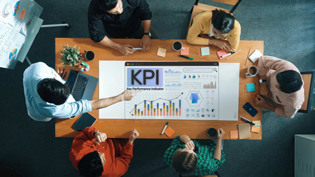Team Collaboration Around a Conference Table Analyzing Dashboard with Key Performance Indicators and Charts for Business Development and Strategy Sigmoid