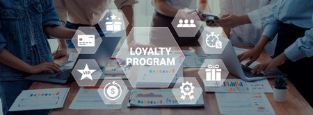 A diverse business team collaborates on loyalty program strategies, using charts and digital tools to enhance customer engagement and drive marketing growth. Ledger