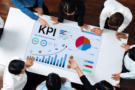 Group of Business Professionals Analyzing Key Performance Indicators on Digital Display in Modern Office Setting. Bitwise.