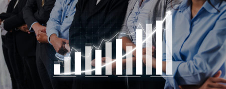 A diverse group of professionals in a business setting discusses growth trends, analyzing charts and graphs to enhance teamwork and strategic planning.
