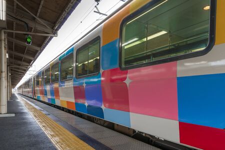 YAMAGATA,JAPAN - APRIL 15,2016 : The sightseeing train "Kirakira Uetsu" at Tsuruoka station. This is the most colorful train in JR East. When it park at station, It like the colorful wall appear.のeditorial素材