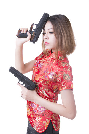 Beautiful woman in red suit hold a guns in her handsの写真素材