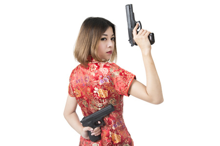 Beautiful woman in red suit hold a guns in her handsの写真素材