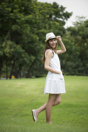 beautiful young woman walking in parkの写真素材