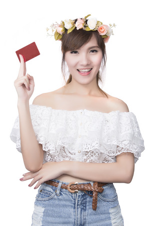 A beautiful woman holds out a business or credit card on Isolated white backgroundの写真素材