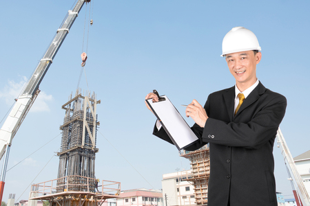 Construction engineer writing plan work on a clipboard.の写真素材