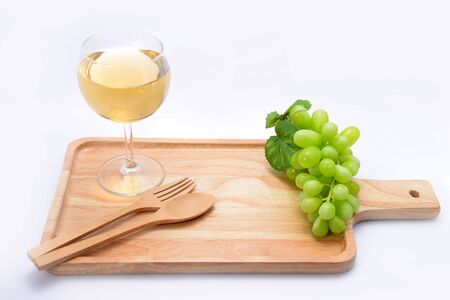 white wine and grapes ona wooden floor.の写真素材
