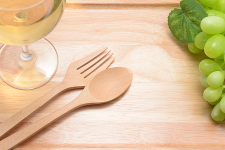 white wine and grapes ona wooden floor.の写真素材