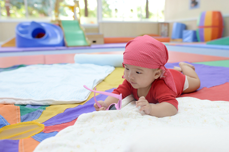 asian cute baby playing in the living room colorful.の写真素材