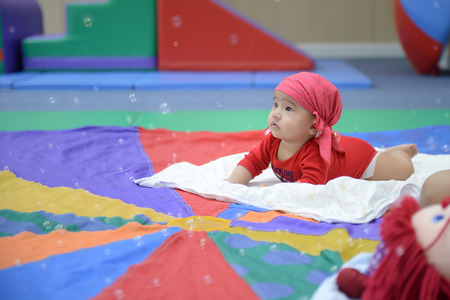Adorable baby look colorful balloons living room.の写真素材