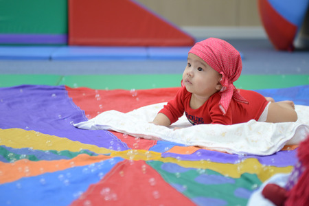 Adorable baby look colorful balloons living room.の写真素材