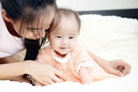 Baby and Mom : Moments of happiness between mother and child.の写真素材