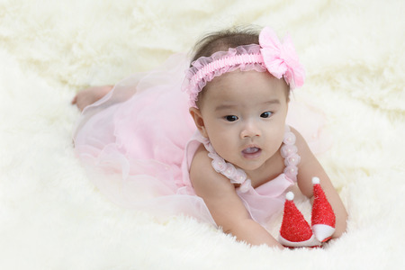 Baby sitting on a soft cloth in the living roomの写真素材